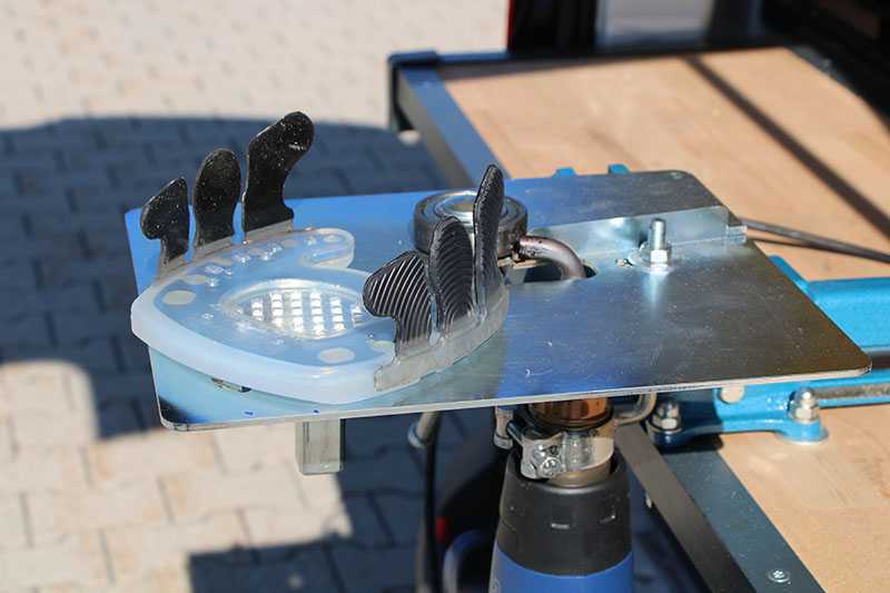 open-toed, glue-on composite horseshoe on plastic-welding device