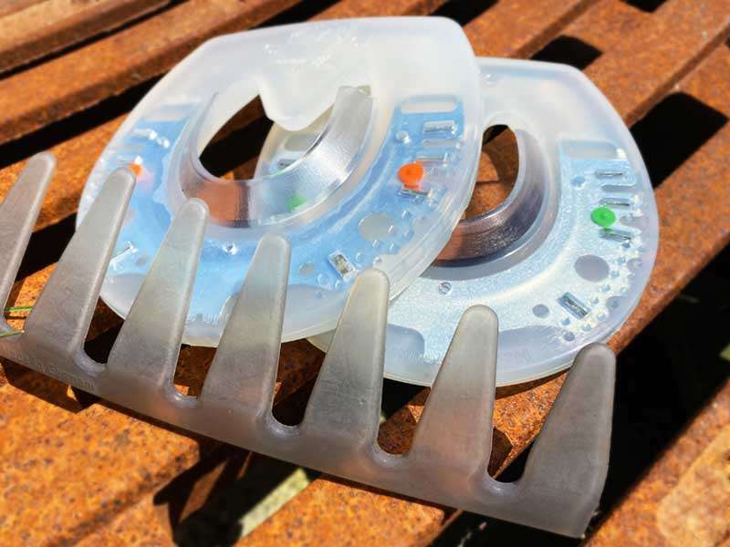 The nailless horse shoe and an adhesive collar are placed on a metal plate