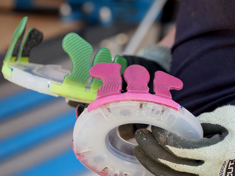 Close-up of finished glue-on shoes with pink and green glue-on tabs using the Nailless as base plate.