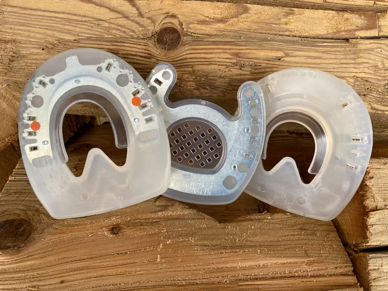 Three horseshoes: open-toe rehab shoe, Classic pure urethane model and Nailless composite shoe, both glue-on, without inserts