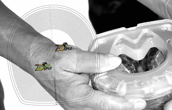 A farrire holding a composite horseshoe against the hoof to determine the correct size.