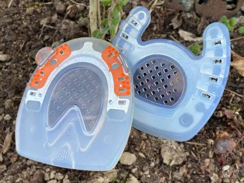 open-toed horseshoe with closed sole area and regular composite shoe with closed sole area standing next to each other