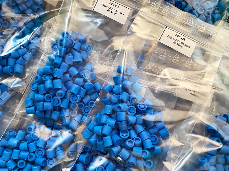 many packs of blue sealing plugs lying next to each other