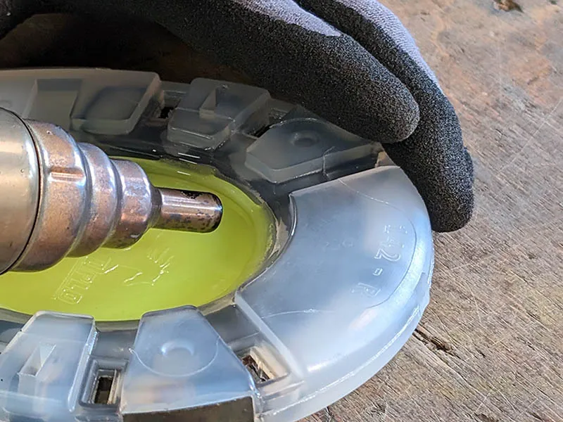 Close-up of welding a hoof sole protector to the plastic coating of a horseshoe using hot air