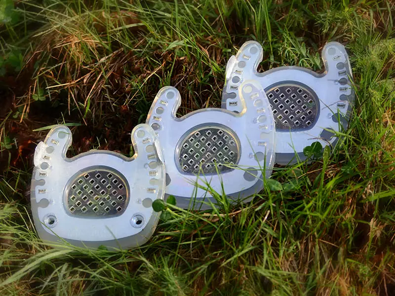 open toe horseshoe, open toe horseshoe with clips and open toe shoe with clips and threaded inserts lie in the gras