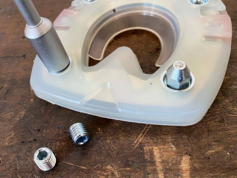 An ice stud is unscrewed from a horseshoe