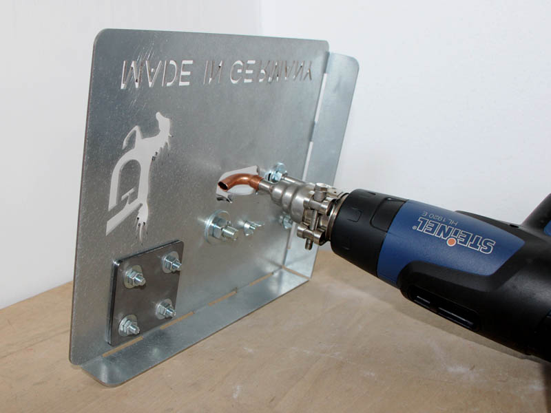 View of the Mini plastic welding device from below, with a blue hot air device attached to it.